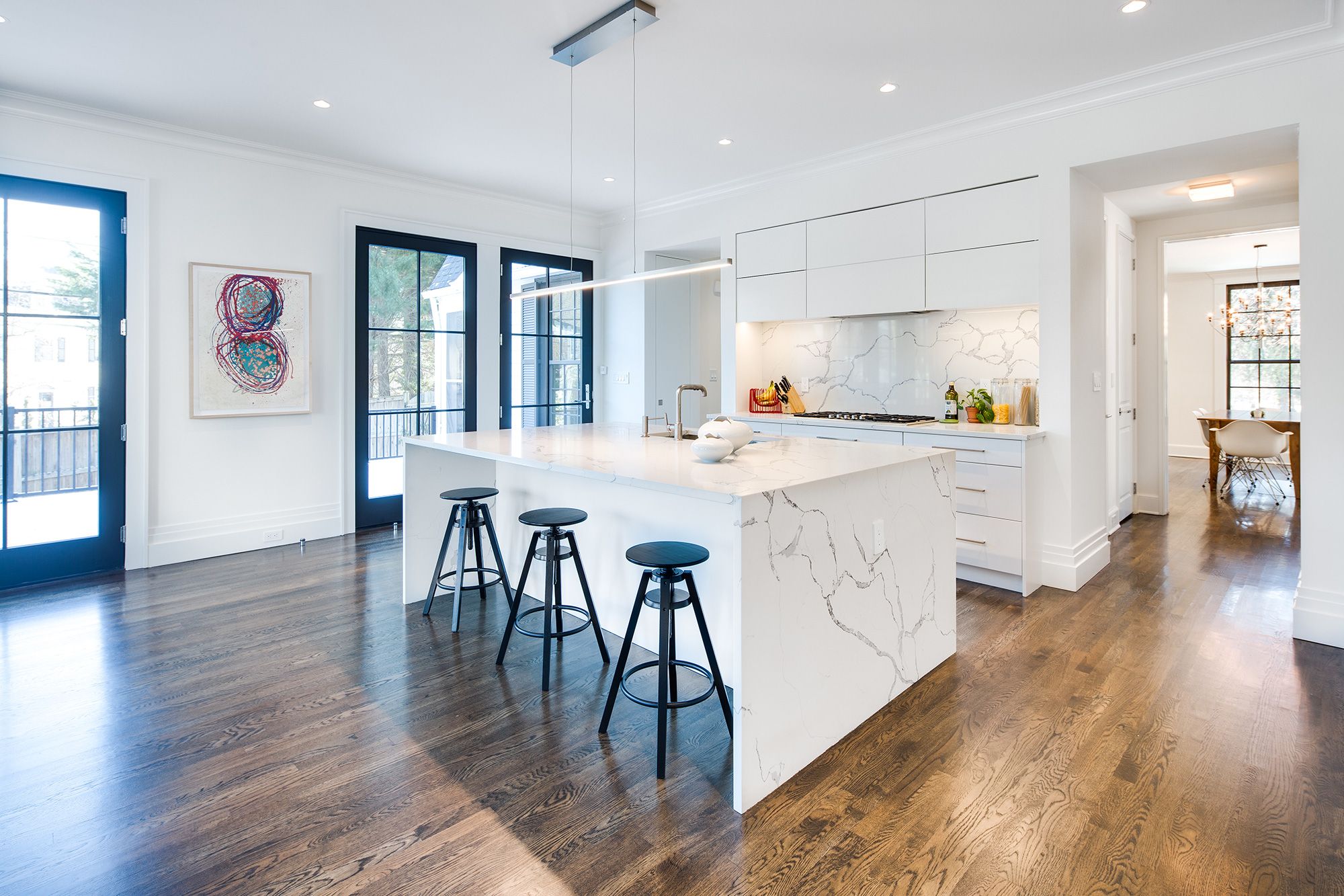 Modern lighting in kitchen with white, marble counters